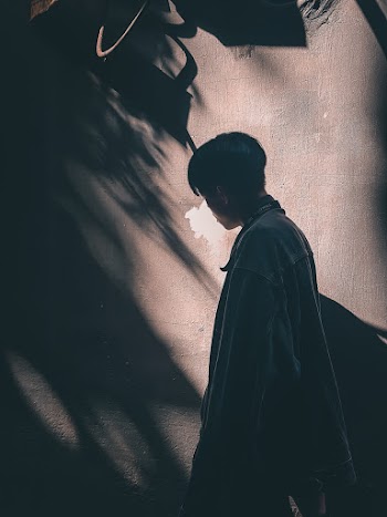 Photo of Man Standing Near Wall