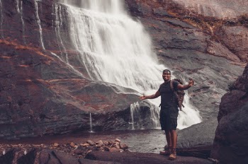 Photo of Man Standing Near Waterfalls