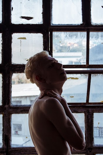 Photo Of Man Standing Near Window