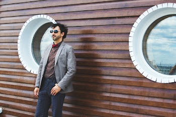 Photo of Man Standing Near Wooden Wall