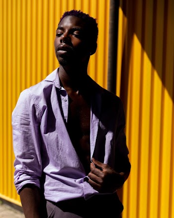 Photo Of Man Standing Near Yellow Wall