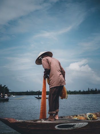 Photo Of Man Standing On Boat
