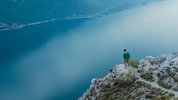 Photo of Man Standing on Cliff 