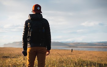 Photo of Man Standing on Grass Field