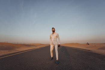 Photo of Man Standing on Roadway
