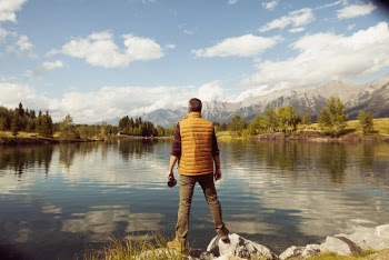 Photo Of Man Standing On Rock