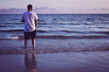 Photo of Man Standing On Seashore