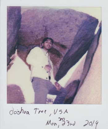 Photo Of Man Standing Under Rock