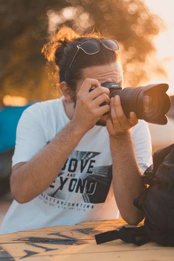 Photo of Man Taking Photo with Dslr Camera