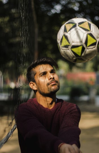 Photo of Man Tossing Volleyball