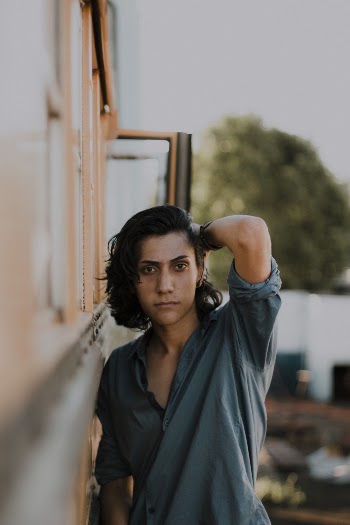 Photo of Man Touching His Hair With His Left Hand