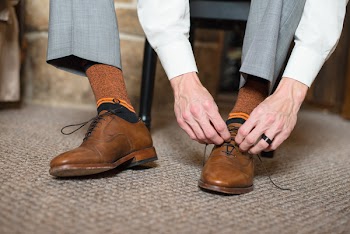 Photo of Man Tying His Shoes