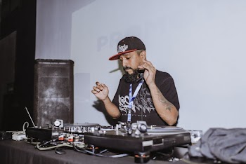 Photo of Man Using Audio Mixer