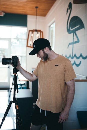 Photo of Man Using Dslr Camera