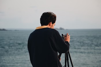 Photo of Man Using His Camera