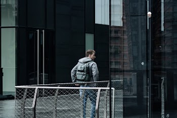 Photo of Man Walking Near Buildings