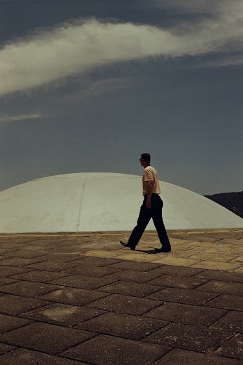Photo of Man Walking Near Stone Dome