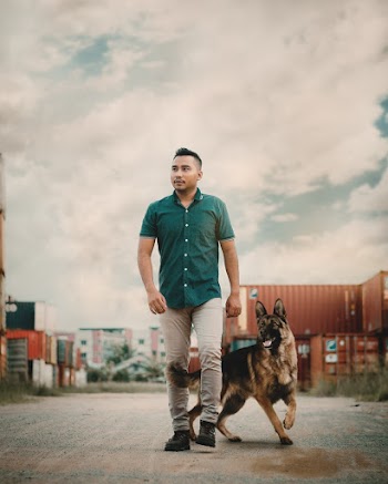Photo of Man Walking With His Dog