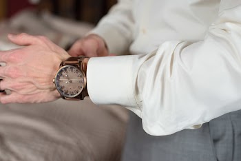 Photo Of Man Wearing Bronze Watch