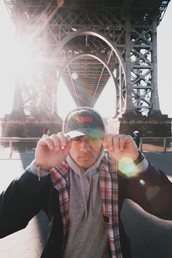 Photo of Man Wearing Cap and Hoodie
