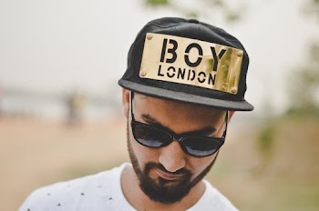 Photo of Man Wearing Cap and Sunglasses