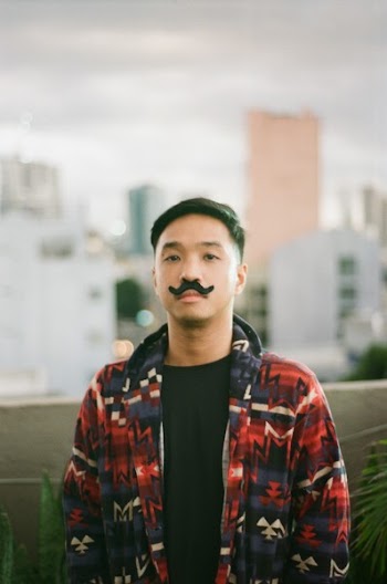 Photo of Man Wearing Fake Mustache and in Red and Blue Zip-up Jacket