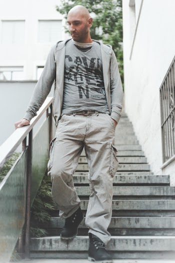 Photo of Man Wearing Grey Zip-up Jacket and Brown Cargo Pants Walking Down on Concrete Stairs