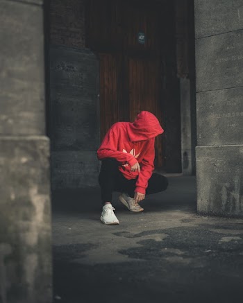Photo of Man Wearing Hoodie While Sitting