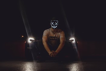 Photo of Man Wearing Mask in Front of Car