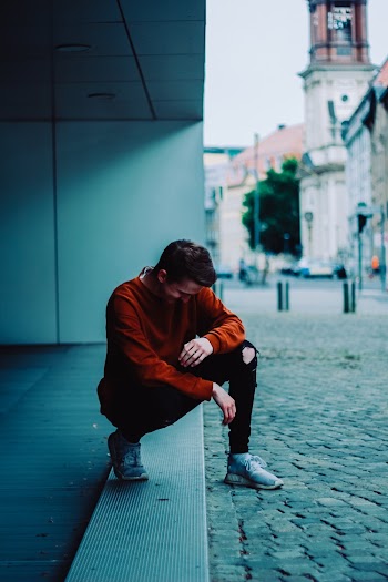 Photo of Man Wearing Orange Sweater