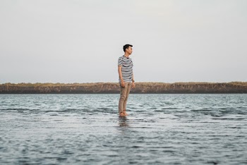 Photo of Man Wearing Striped Shirt