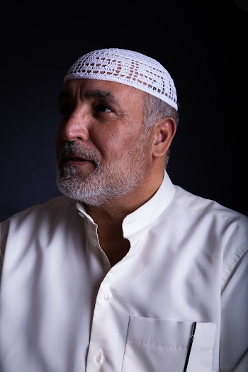 Photo of Man Wearing White Top and White Headwear