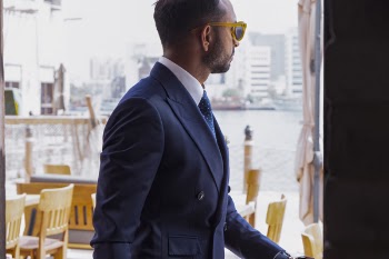 Photo of Man Wears Black Shawl-lapel Blazer and Yellow Rimmed Sunglasses