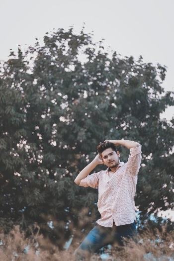 Photo of Man with His Hands Raised Over His Head Posing