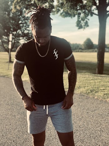 Photo of Man With Tattoos While Standing Outdoors