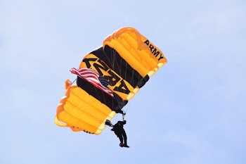 photo of man with yellow Army parachute