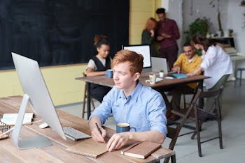 Photo Of Man Writing On Notepad