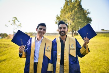 Photo Of Men Holding Graduation Cap