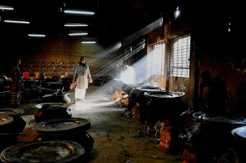 Photo Of Men Near Big Pots