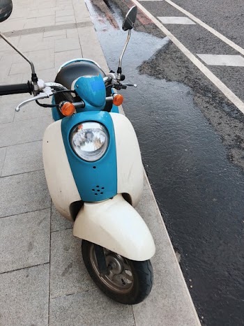Photo of Motor Scooter Parked On Pavement