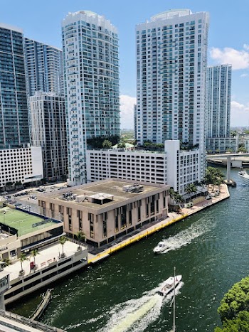 Photo of Motorboats on River Near Buildings