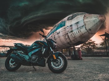 Photo of Motorcycle Near Airplane