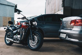 Photo of Motorcycle Parked Near Cars