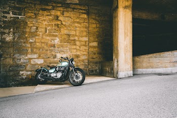 Photo of Motorcycle Parked On a Sloped Pavement
