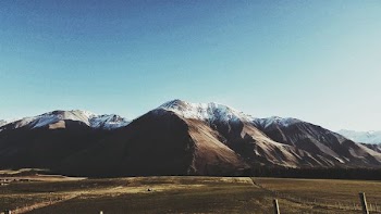 photo of mountain and green field