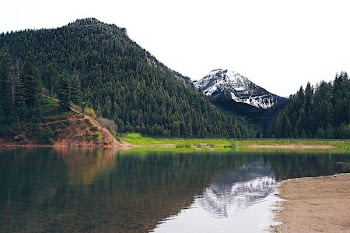 photo of mountain near river at daytime