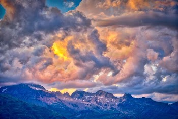 photo of mountain range under golden sky