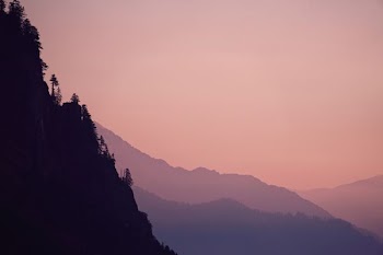 photo of mountain under white sky