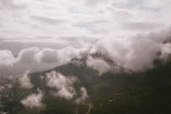 Photo Of Mountains Under Cloudy Sky