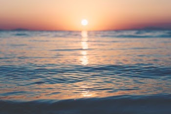photo of ocean during golden hour